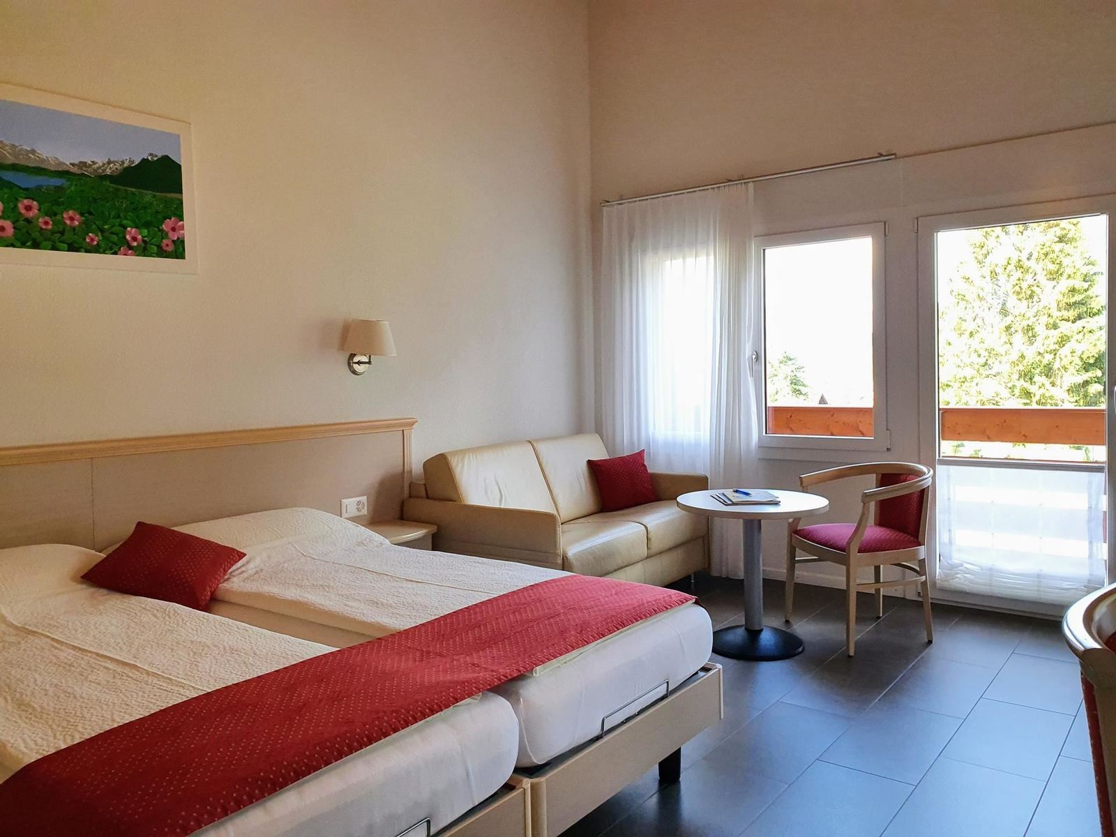 Guest room with sofa and large windows