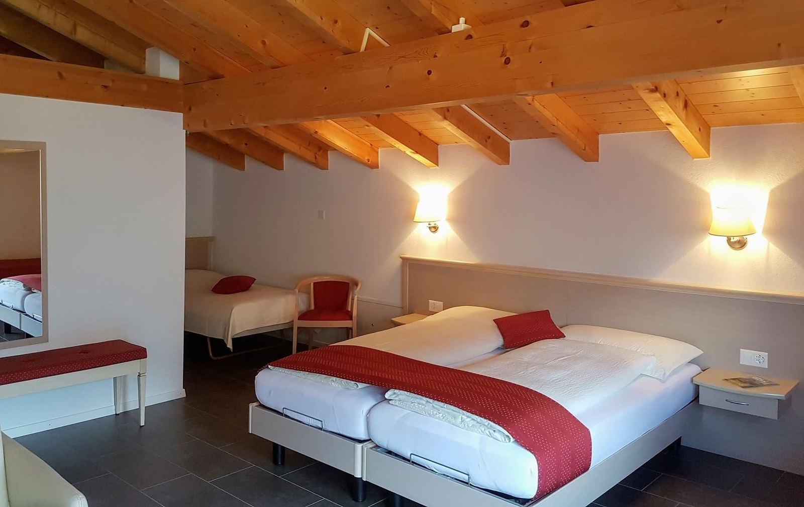 Guest room with twin beds and red bedspreads